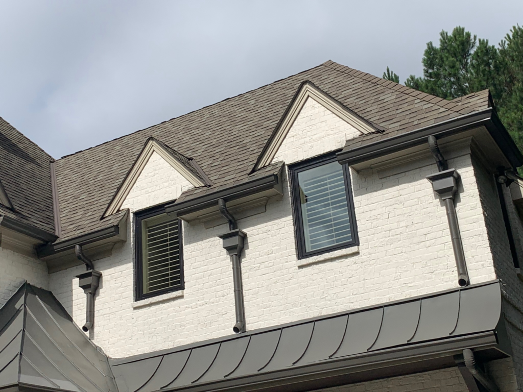 Aging roof shingles close-up showing wear, cracks, and deterioration indicating need for roof replacement