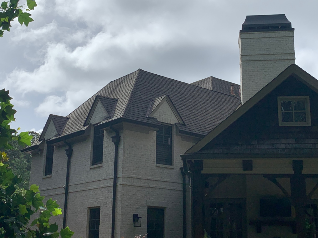 Residential roof showing subtle signs of storm aftermath without severe damage