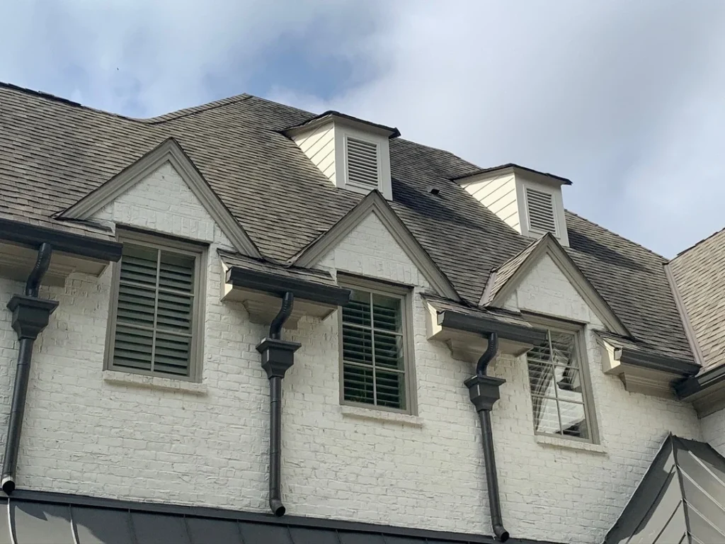 Residential roof shingles showing subtle wear and early signs of damage